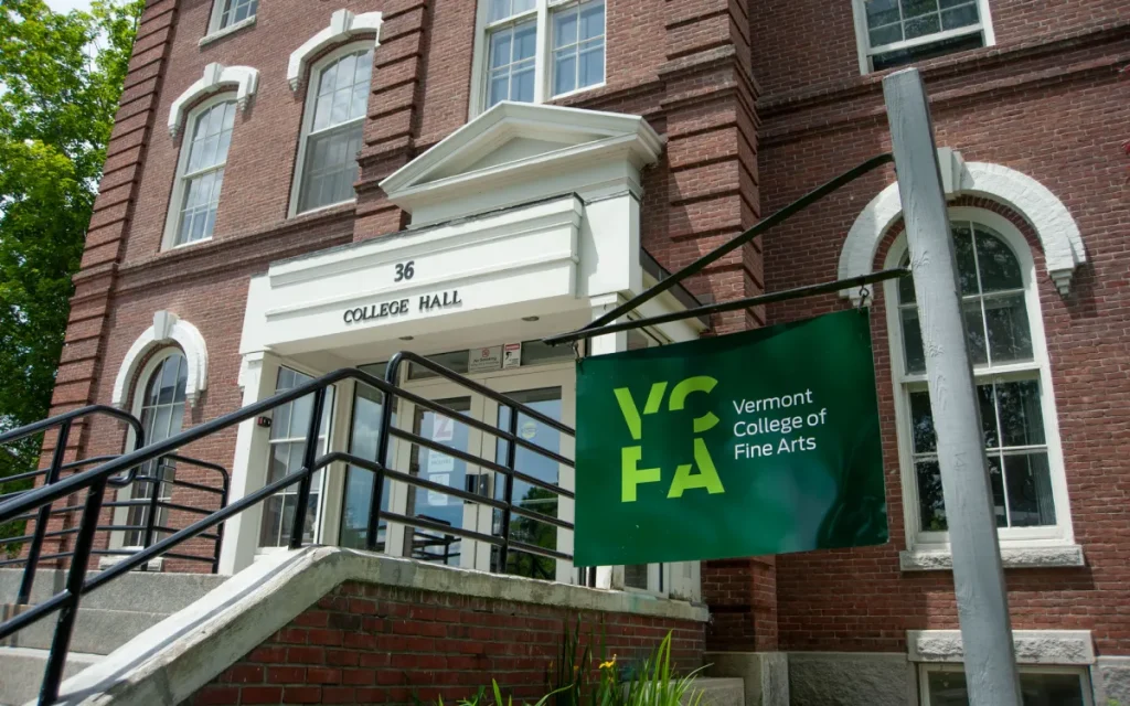 Red brick building with Vermont College of Fine Arts flag in front.